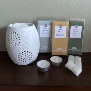 A gift set of wax melts with a wax melt burner
